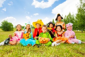 Smiling children in Halloween costumes together